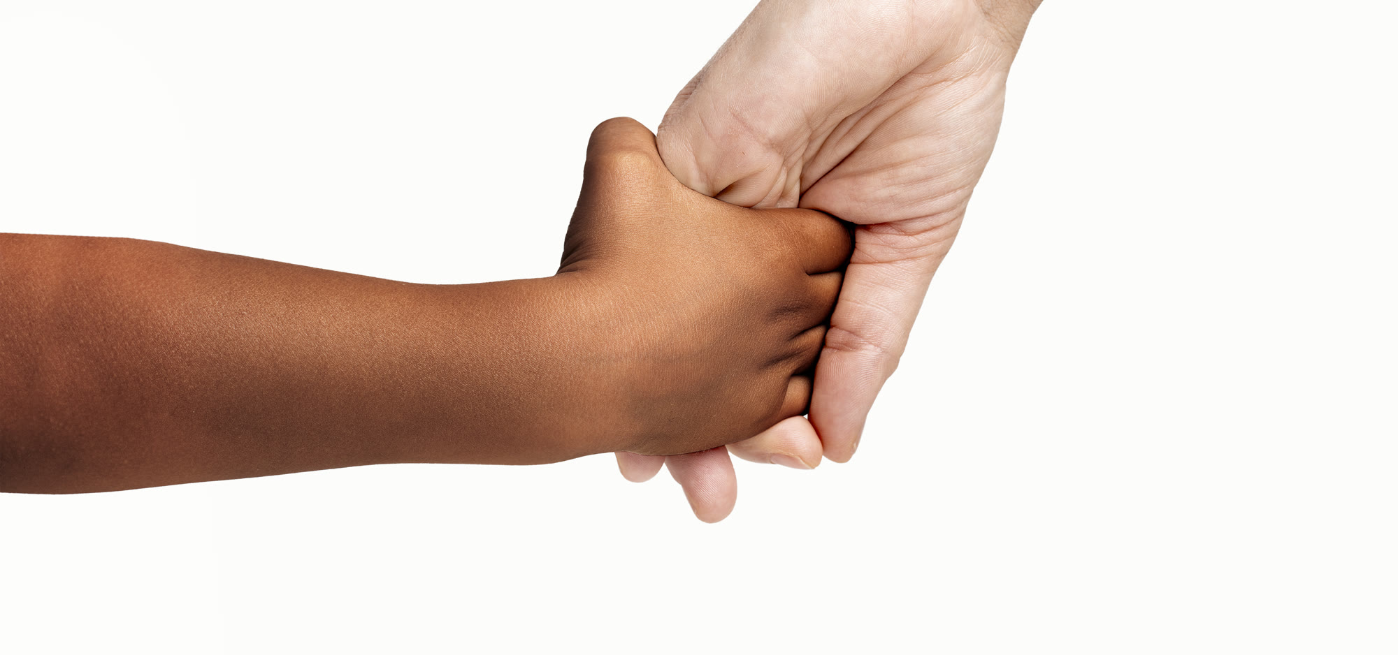 A child holding a grown-up’s hand